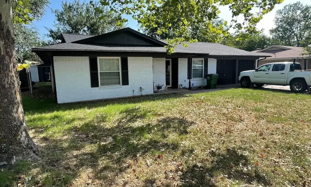 Professional roofing crew working on a residential roof in Port Jefferson